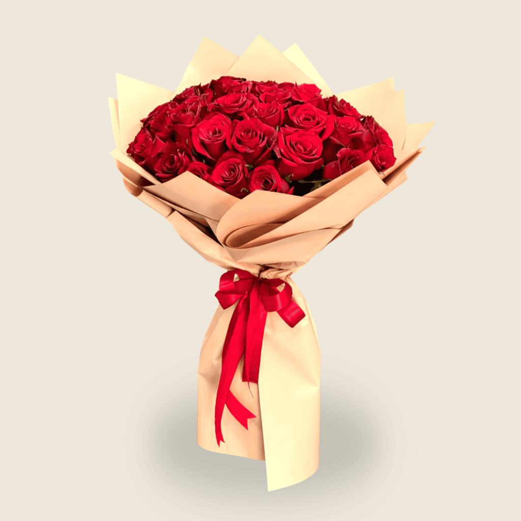 Classic bouquet of red roses wrapped in kraft paper with red ribbon