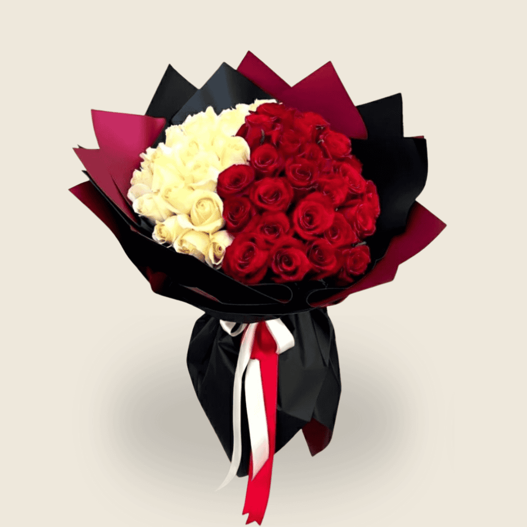 Bouquet of red and white roses wrapped in black and burgundy