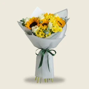 Sunflowers and crisp whites tied in a modern handheld wrap. Bursting with energy and light, the kind of bouquet that turns an ordinary day into a celebration.