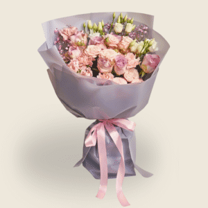 Pastel bouquet of roses, lisianthus and carnations in lavender wrapping