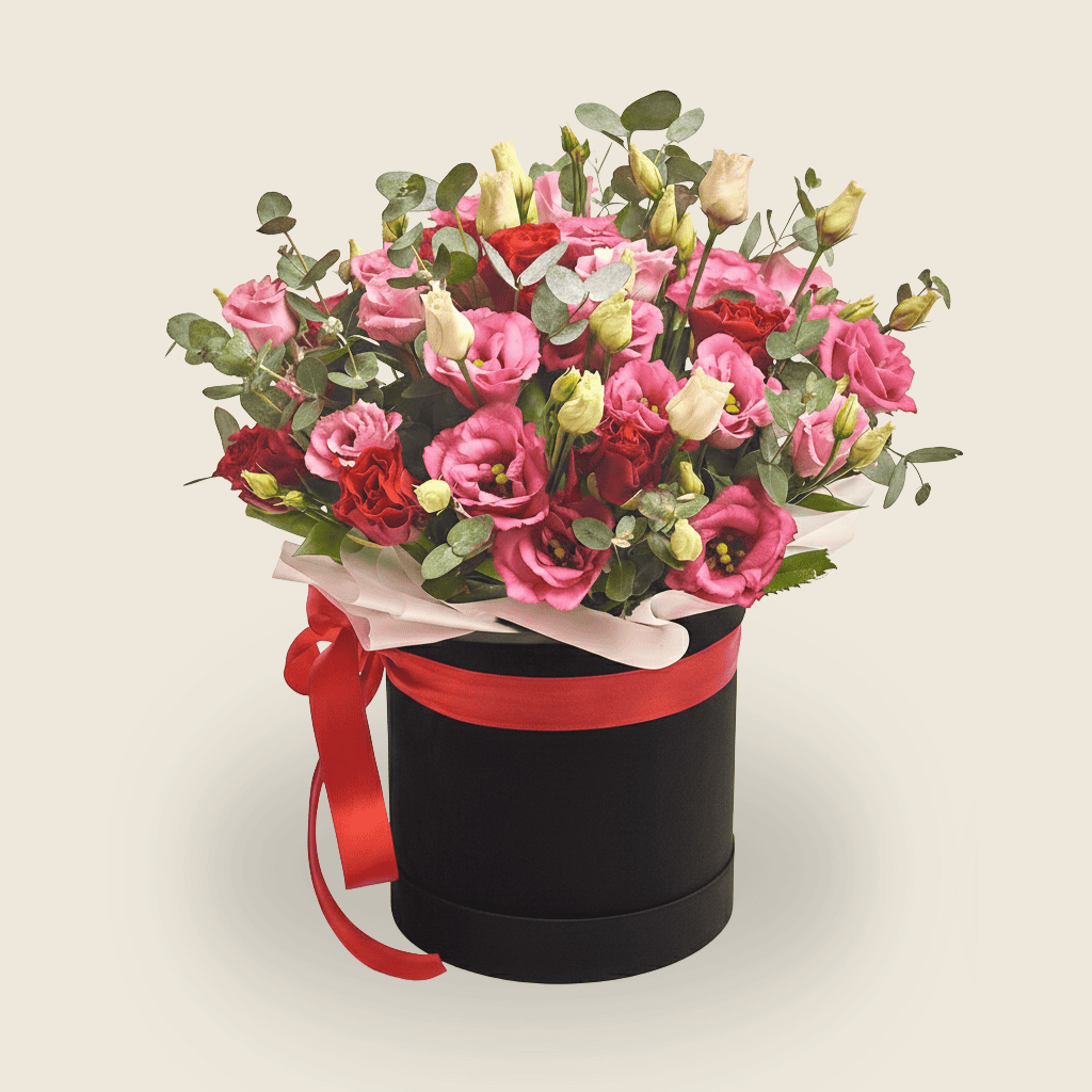 Birthday hatbox arrangement with pink Eustoma red roses, and eucalyptus