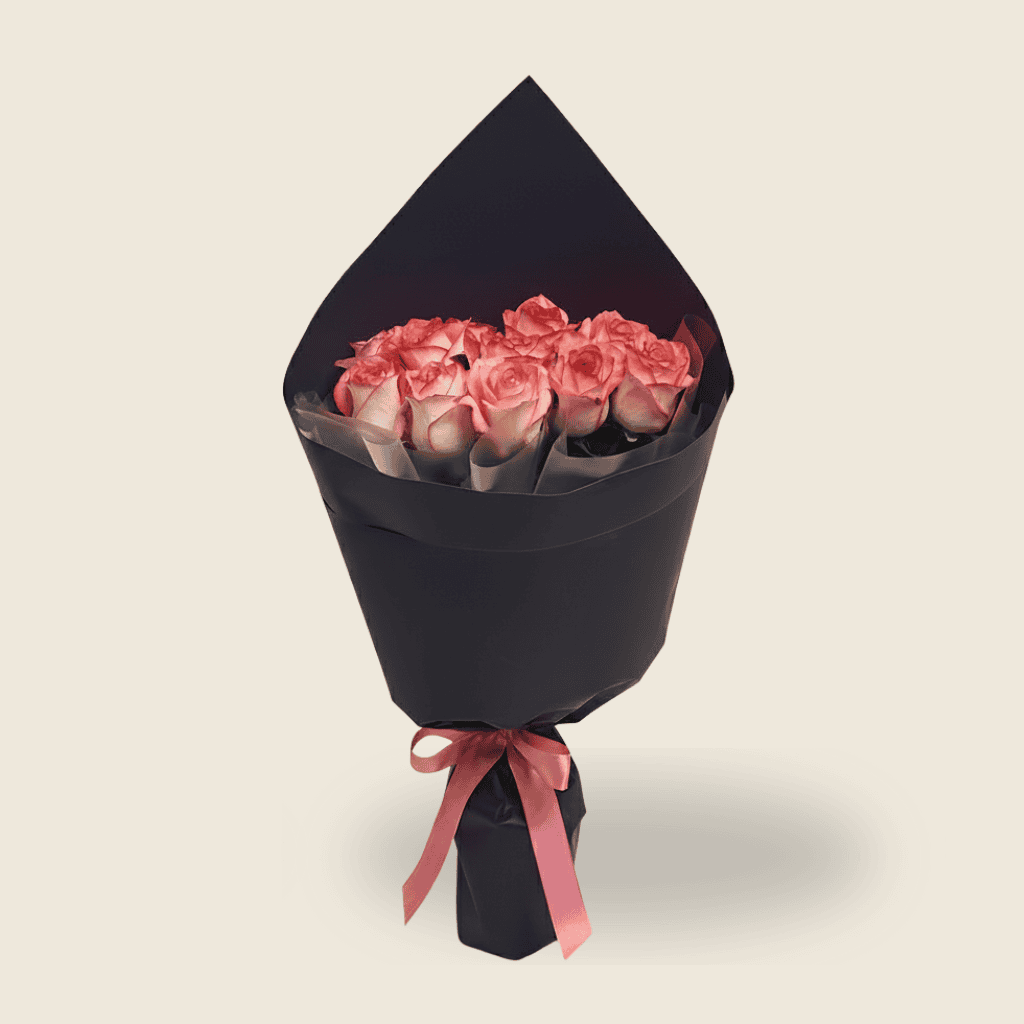 Chic bouquet of soft pink roses in black wrapping