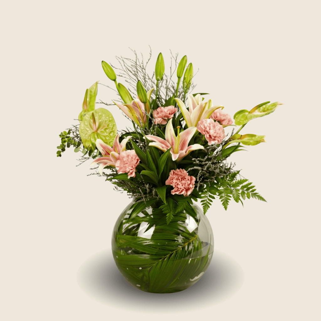 Elegant vase arrangement of pink lilies, carnations, and green anthuriums
