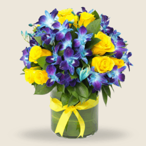 Blue orchids and yellow roses in a round vase tied with a yellow ribbon