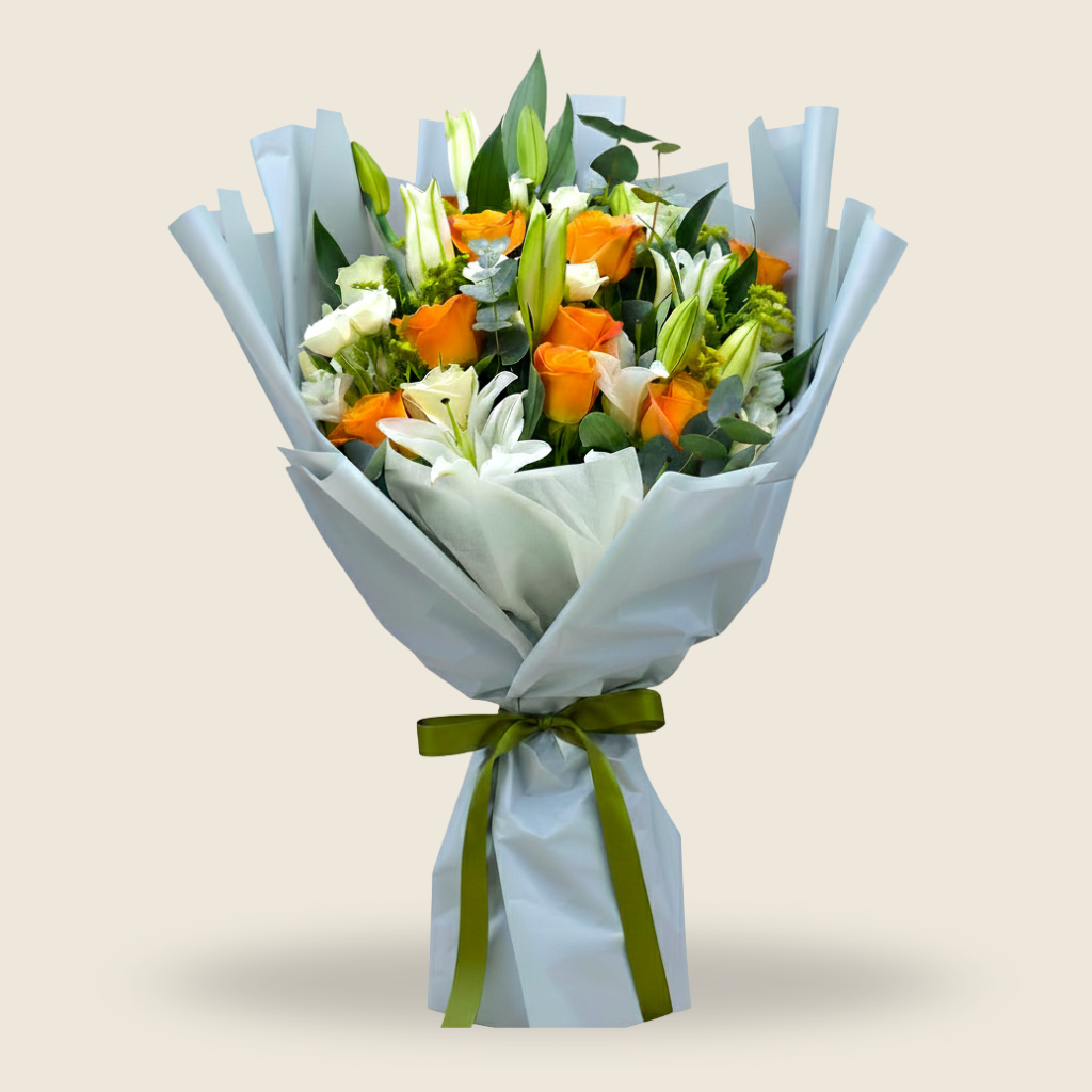 Elegant bouquet of white lilies and orange roses wrapped in grey and white paper