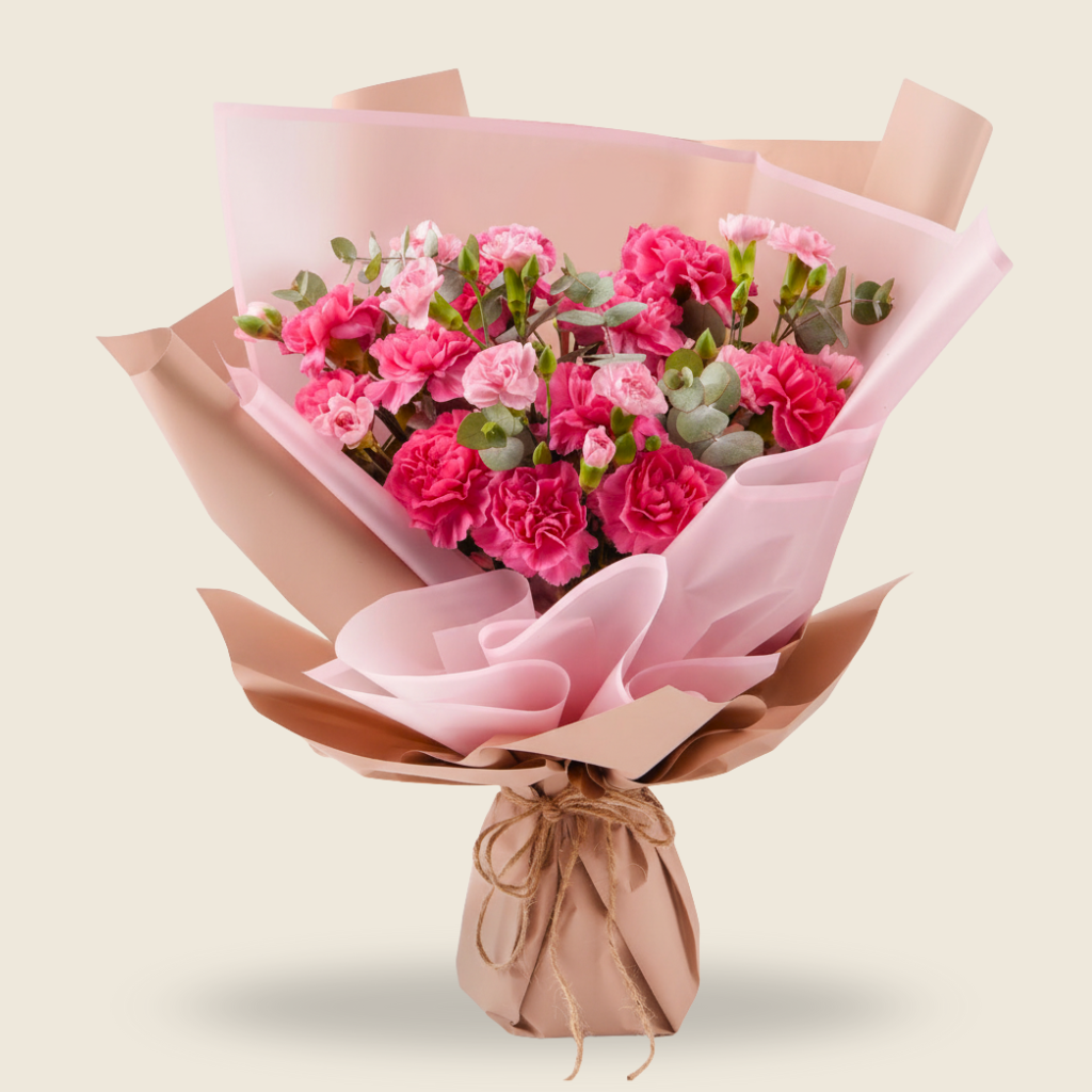 Charming bouquet of pink carnations in rustic wrap