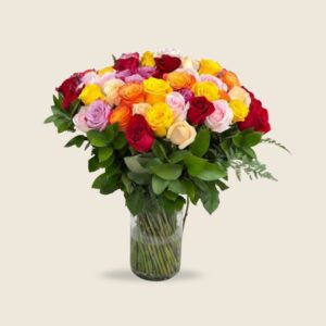 Multicolor rose bouquet in tall glass vase with vibrant blooms